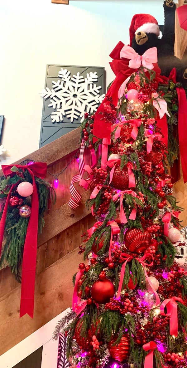 Garland and ribbon on a wooden staircase railing